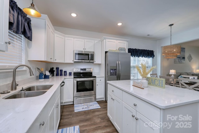 kitchen with dark wood-style floors, recessed lighting, a sink, white cabinets, and appliances with stainless steel finishes