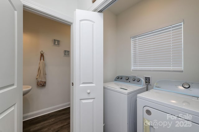 laundry room featuring baseboards, independent washer and dryer, dark wood-style floors, and laundry area