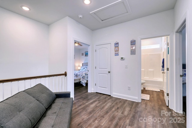 hall with recessed lighting, baseboards, attic access, and dark wood finished floors