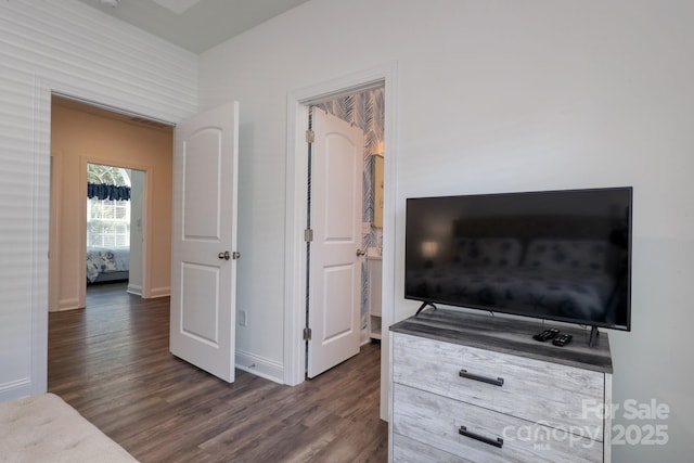 bedroom with baseboards and dark wood finished floors