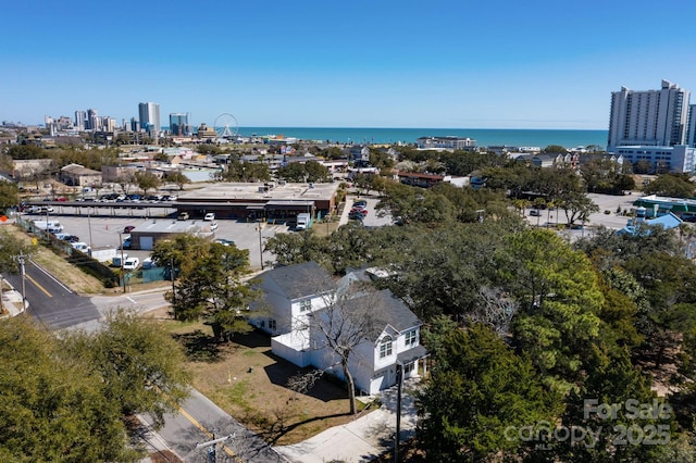 birds eye view of property with a water view and a view of city