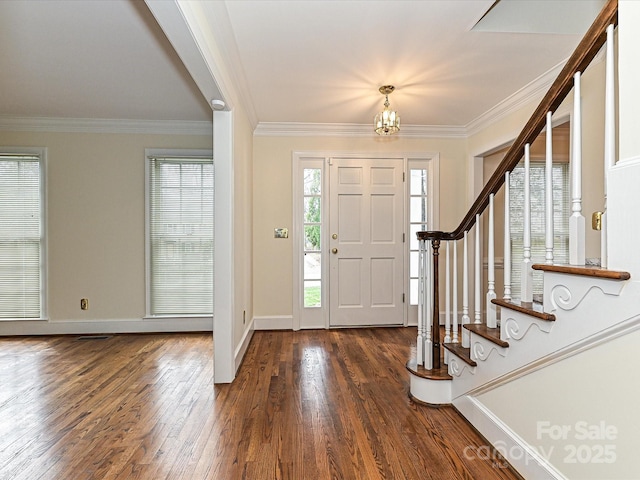 entrance foyer with stairs, dark wood-type flooring, and ornamental molding