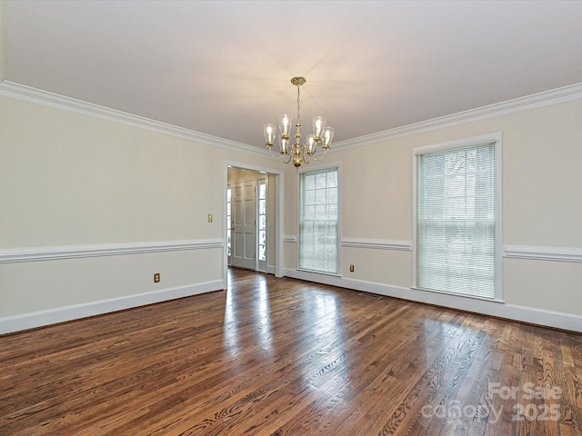 unfurnished room featuring an inviting chandelier, baseboards, dark wood-style flooring, and ornamental molding