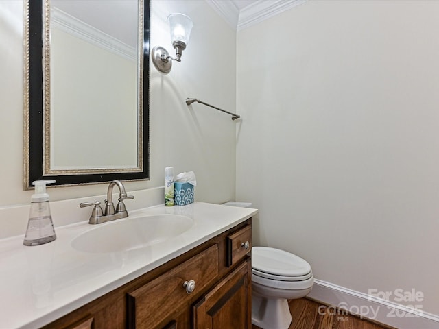 half bathroom with wood finished floors, toilet, ornamental molding, and vanity