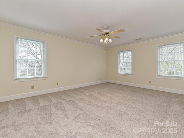 spare room featuring visible vents, baseboards, light colored carpet, and ornamental molding