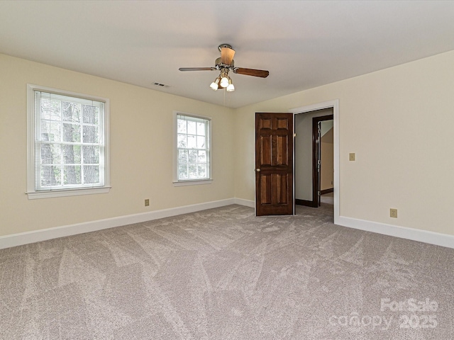 spare room featuring visible vents, ceiling fan, baseboards, and carpet