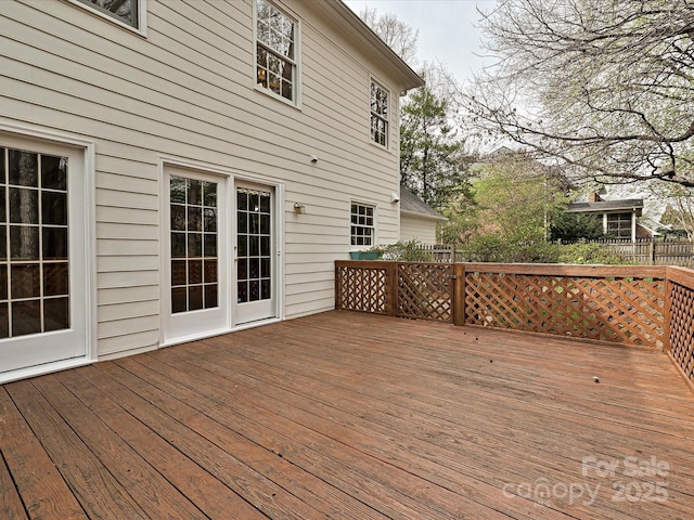 wooden terrace featuring fence