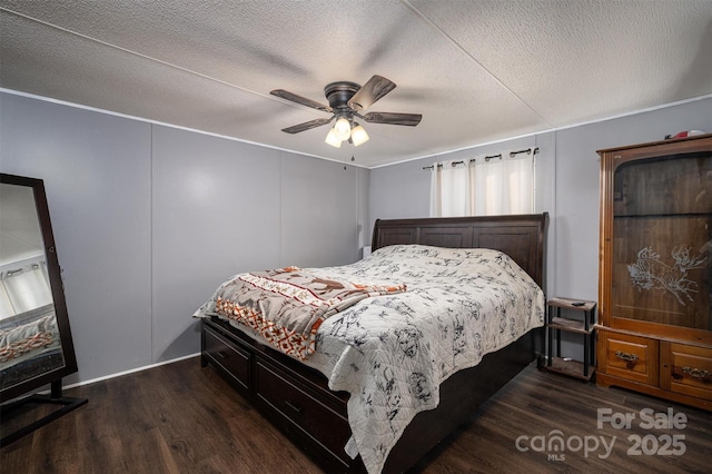 bedroom with dark wood-type flooring, ceiling fan, and a textured ceiling