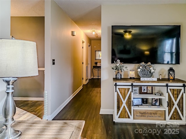 hallway with baseboards and wood finished floors