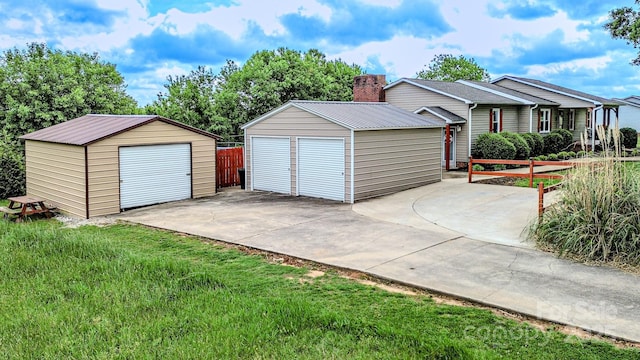 detached garage featuring fence