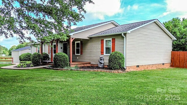 view of front of house featuring fence, roof with shingles, a front lawn, crawl space, and covered porch