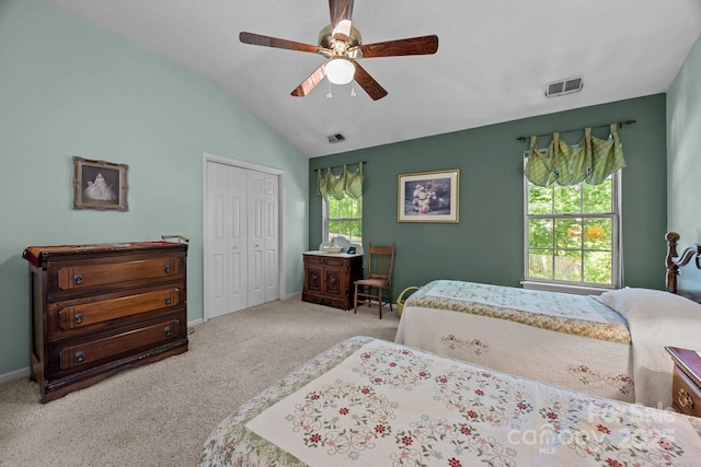 bedroom with carpet flooring, a closet, lofted ceiling, ceiling fan, and baseboards