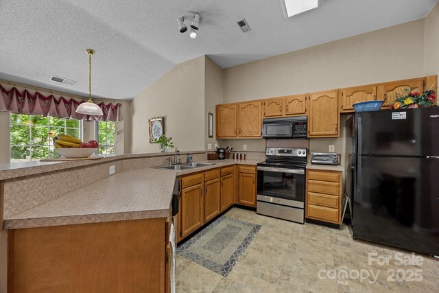 kitchen with black appliances, a sink, lofted ceiling, a peninsula, and pendant lighting