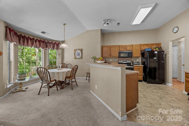 kitchen featuring black appliances, vaulted ceiling, baseboards, light countertops, and decorative light fixtures