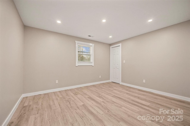 empty room with recessed lighting, baseboards, and light wood finished floors