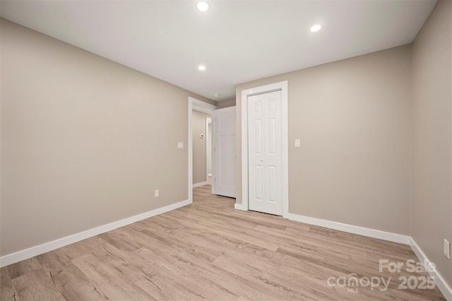 unfurnished bedroom featuring baseboards and light wood finished floors