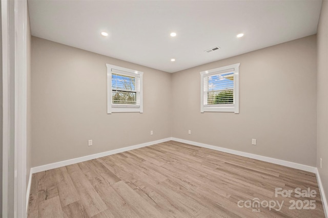 spare room with recessed lighting, baseboards, visible vents, and light wood finished floors