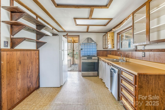 kitchen featuring light floors, a sink, light countertops, glass insert cabinets, and appliances with stainless steel finishes