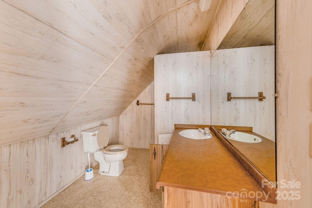 bathroom featuring toilet, wood walls, lofted ceiling, wood ceiling, and vanity