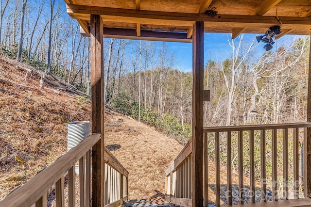 wooden deck with a view of trees