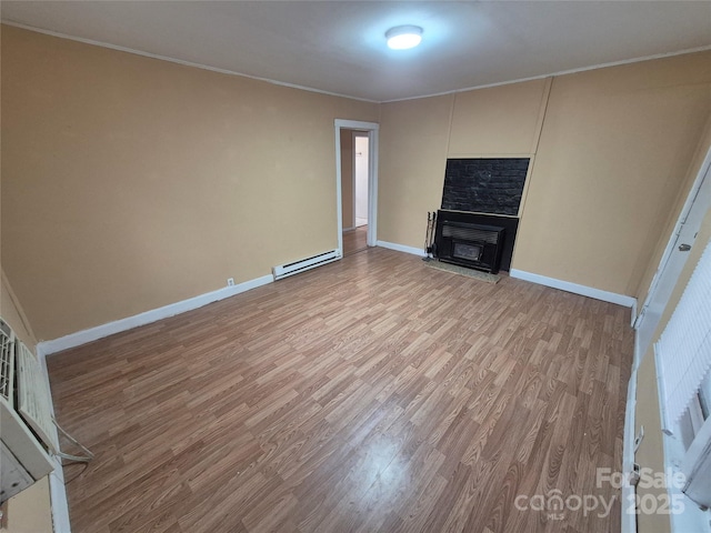 unfurnished living room with baseboards, light wood finished floors, a baseboard radiator, a fireplace, and ornamental molding