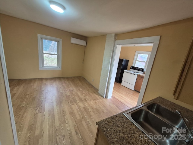 interior space featuring light wood-style floors and a wall unit AC