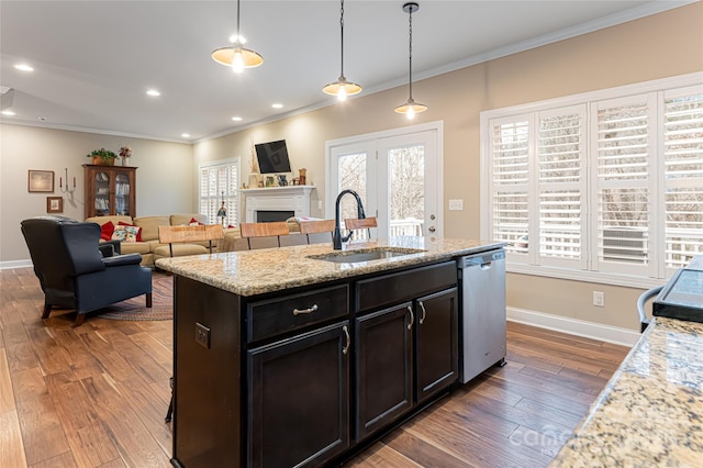 kitchen featuring hardwood / wood-style flooring, stainless steel dishwasher, crown molding, and a sink