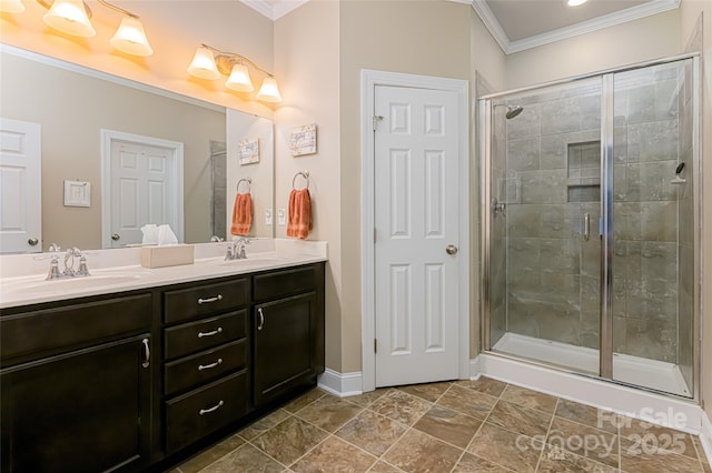 bathroom featuring double vanity, ornamental molding, a stall shower, and a sink