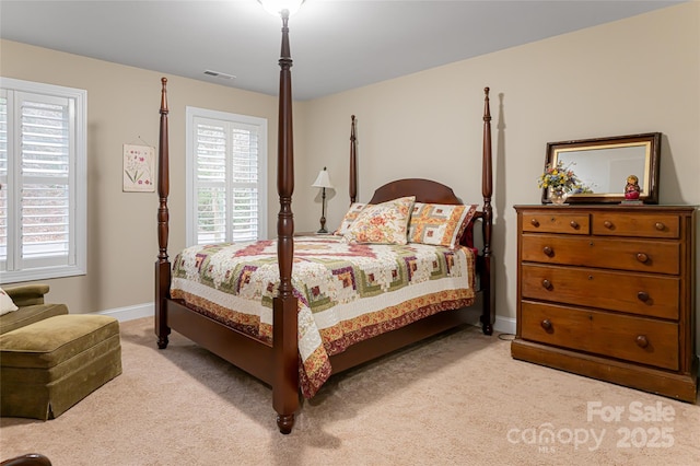 bedroom with light carpet, visible vents, and baseboards