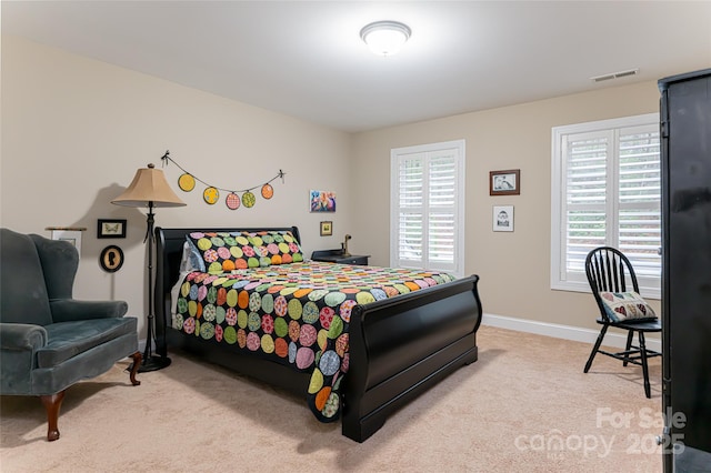 bedroom featuring carpet flooring, visible vents, and baseboards