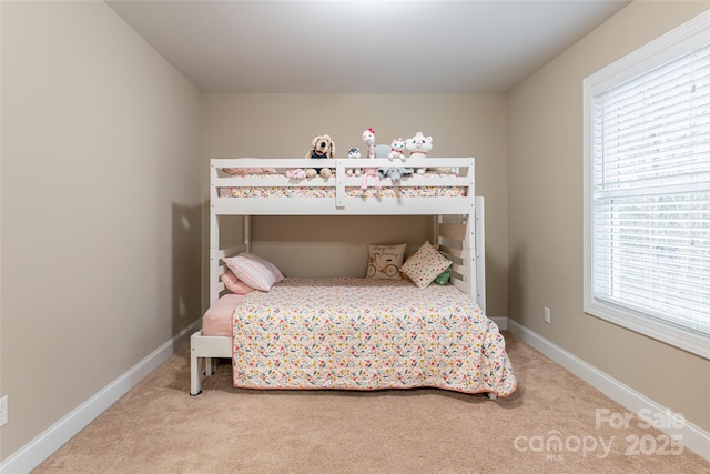 carpeted bedroom featuring baseboards