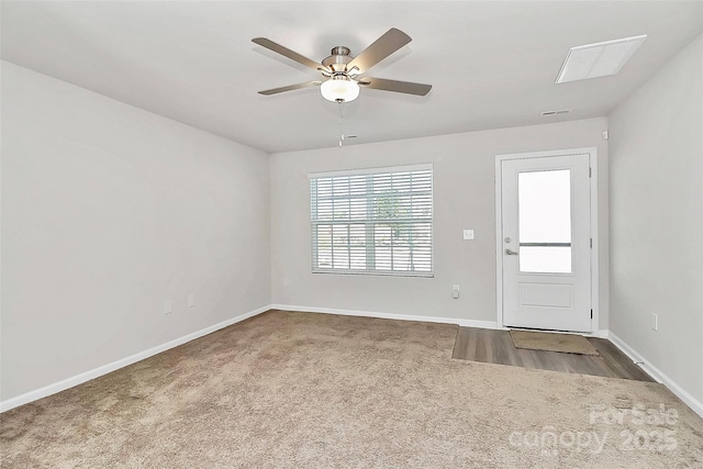 entryway featuring ceiling fan, baseboards, and carpet floors