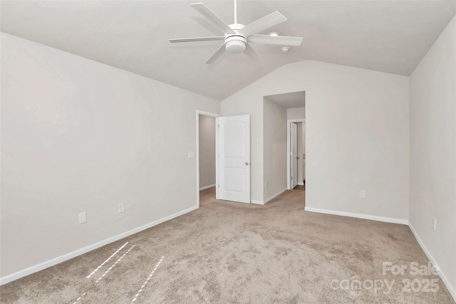 empty room featuring vaulted ceiling, baseboards, a ceiling fan, and carpet floors