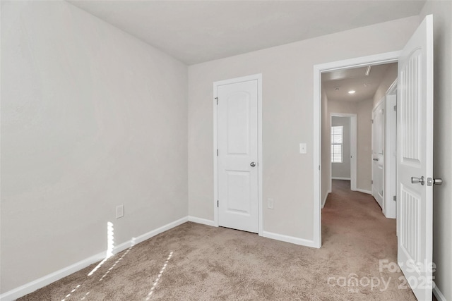 unfurnished bedroom featuring baseboards and carpet flooring