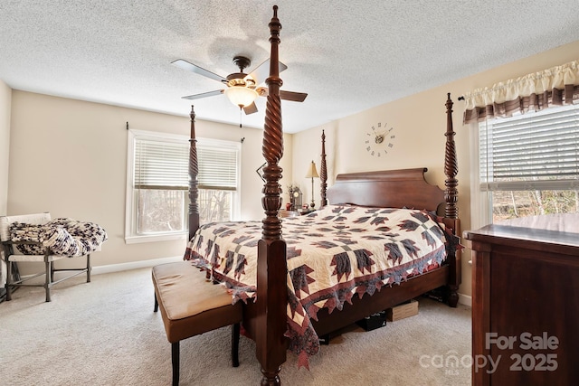 carpeted bedroom featuring a textured ceiling, multiple windows, and ceiling fan