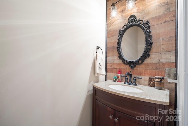 bathroom with wood walls and vanity