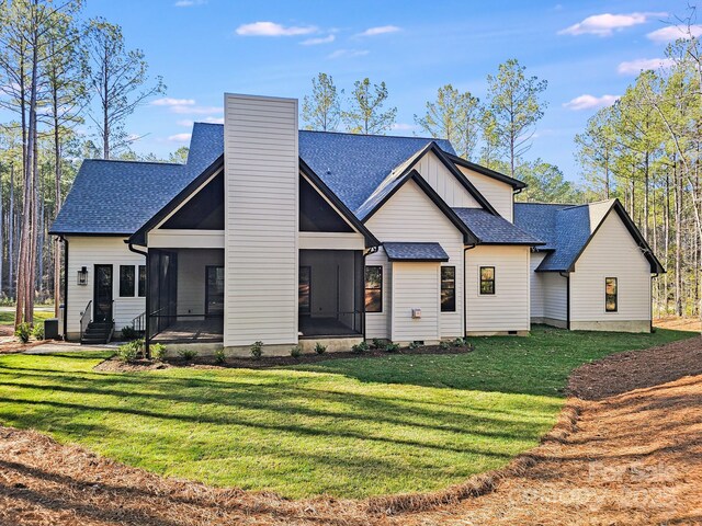 4354 Persimmon Rd, Lancaster, SC 29720 - back of property with a sunroom, a chimney, a shingled roof, and a lawn