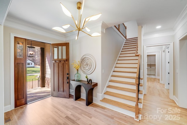 4354 Persimmon Rd, Lancaster, SC 29720 - entryway with crown molding, stairway, a chandelier, wood finished floors, and baseboards