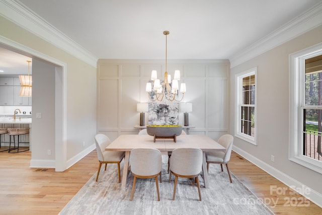 4354 Persimmon Rd, Lancaster, SC 29720 - dining room with a chandelier, crown molding, and light wood finished floors