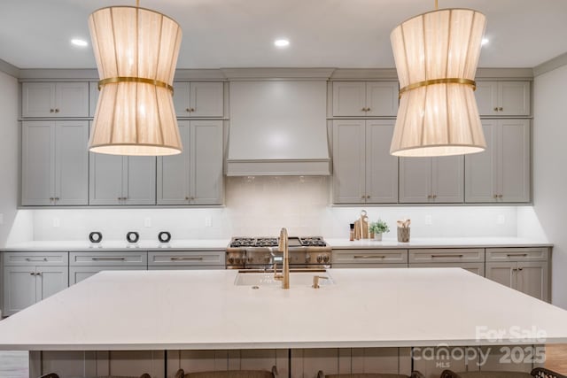 4354 Persimmon Rd, Lancaster, SC 29720 - kitchen with a kitchen bar, a sink, custom range hood, and gray cabinetry