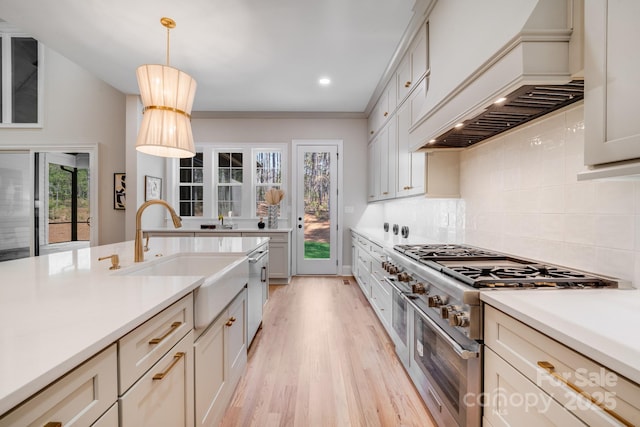 4354 Persimmon Rd, Lancaster, SC 29720 - kitchen with custom exhaust hood, a sink, light wood finished floors, stainless steel appliances, and backsplash