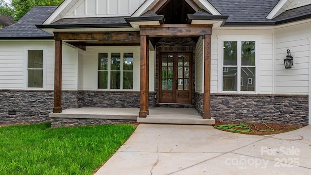 3732 Whitney Dr NE, Hickory, NC 28601 - view of exterior entry with stone siding, a shingled roof, french doors, board and batten siding, and a porch