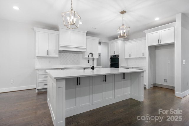 3732 Whitney Dr NE, Hickory, NC 28601 - kitchen featuring a chandelier, tasteful backsplash, recessed lighting, white cabinets, and a kitchen island with sink