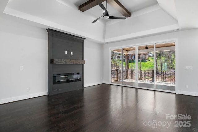 3732 Whitney Dr NE, Hickory, NC 28601 - unfurnished living room featuring ceiling fan, a tray ceiling, a large fireplace, dark wood-style flooring, and beam ceiling
