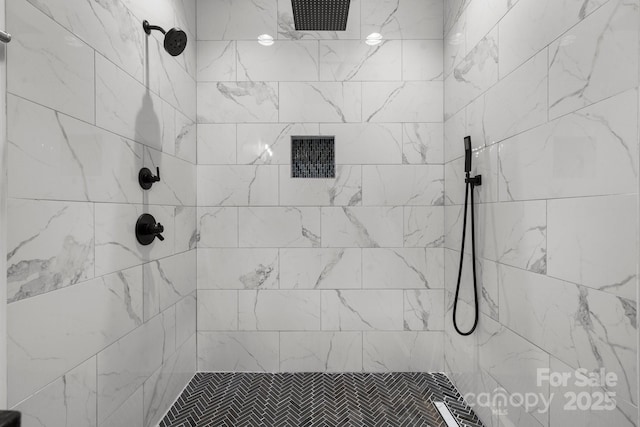 full bath featuring a tile shower