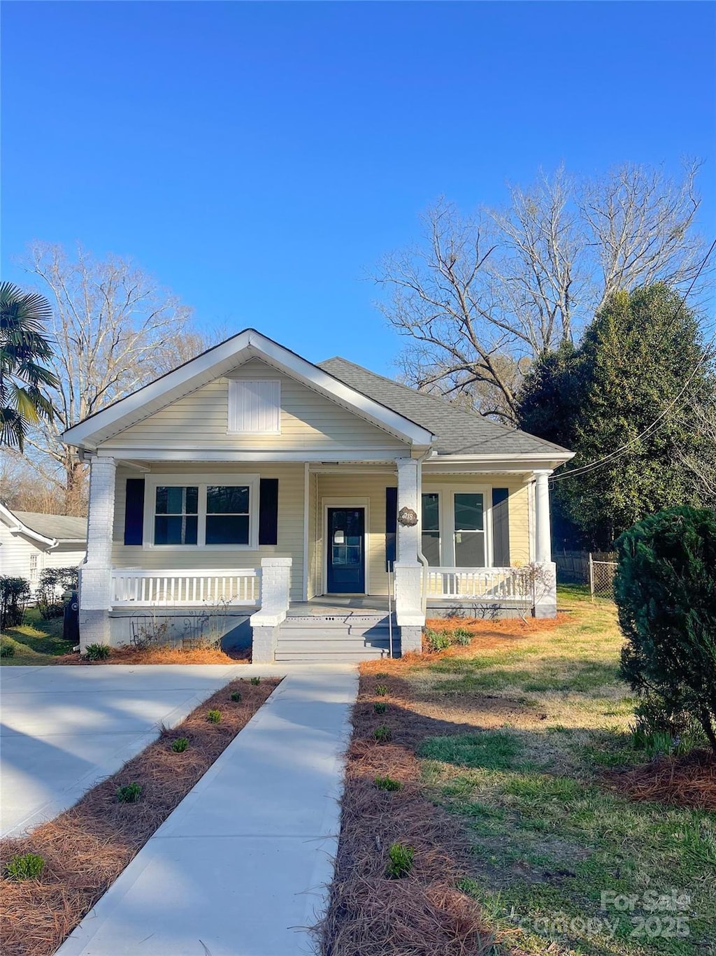 bungalow with a porch and a front yard