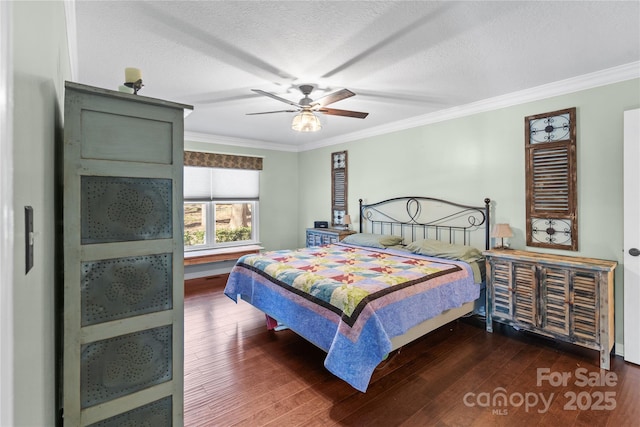 bedroom with ceiling fan, crown molding, dark wood-style flooring, and a textured ceiling