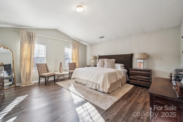 bedroom featuring visible vents, lofted ceiling, baseboards, and dark wood-style floors