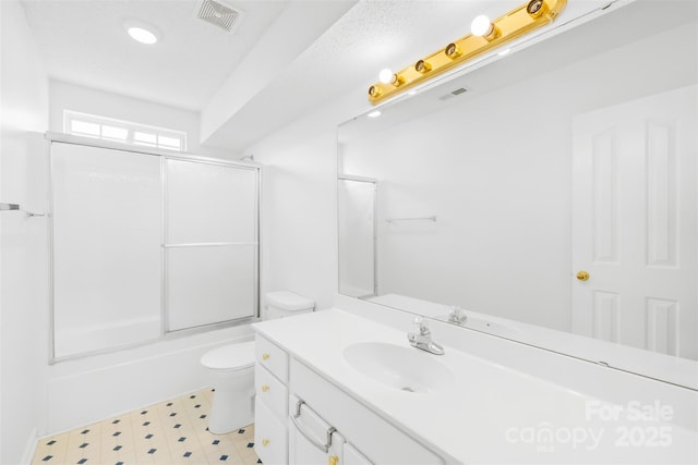 full bathroom with vanity, tile patterned floors, toilet, and visible vents