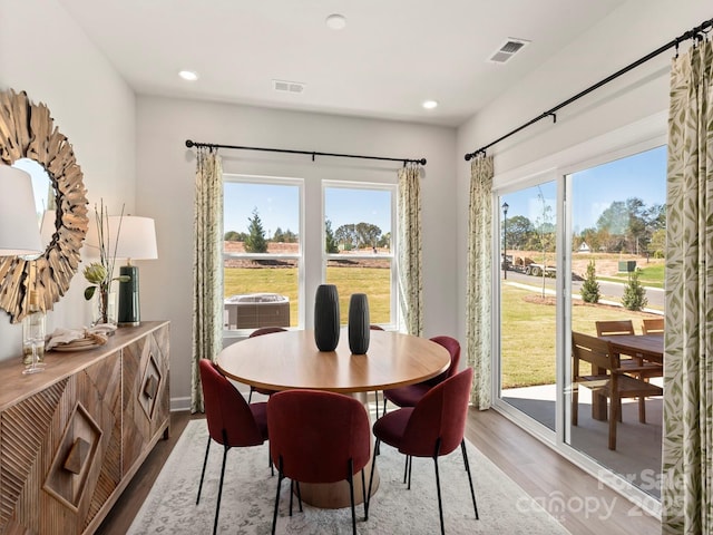 dining space with visible vents, recessed lighting, and wood finished floors